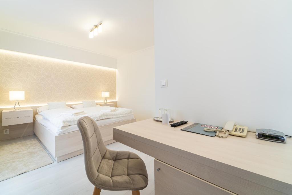 Postel nebo postele na pokoji v ubytování Hotel Artin