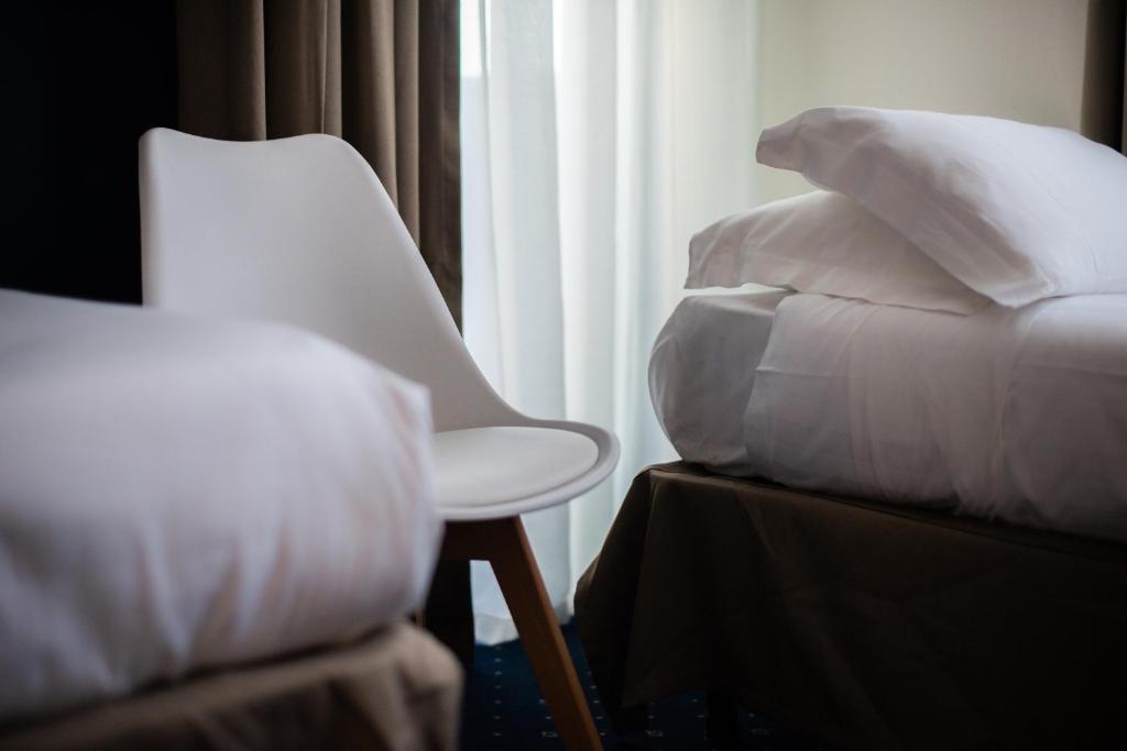 Postel nebo postele na pokoji v ubytování Hotel Glis