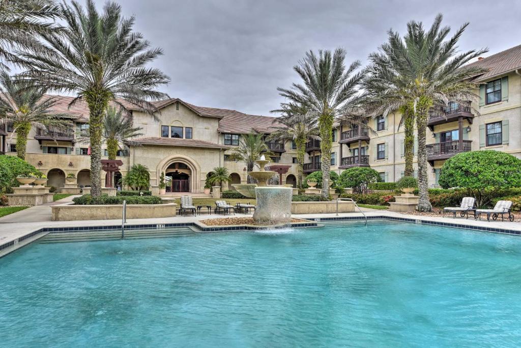 una piscina di fronte a un edificio con palme di World Golf Village Resort Escape with Pool Access! a St. Augustine