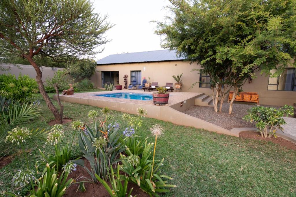 a house with a swimming pool in a yard at Asuite-Dream in Hoedspruit