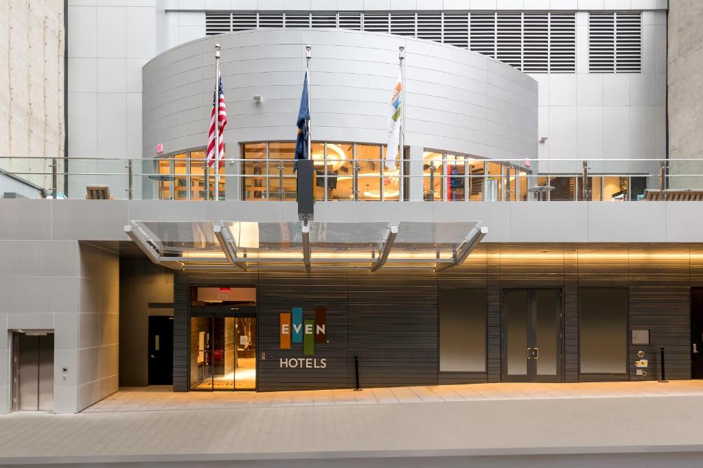 a building with two flags in front of it at EVEN Hotel New York - Midtown East, an IHG Hotel in New York