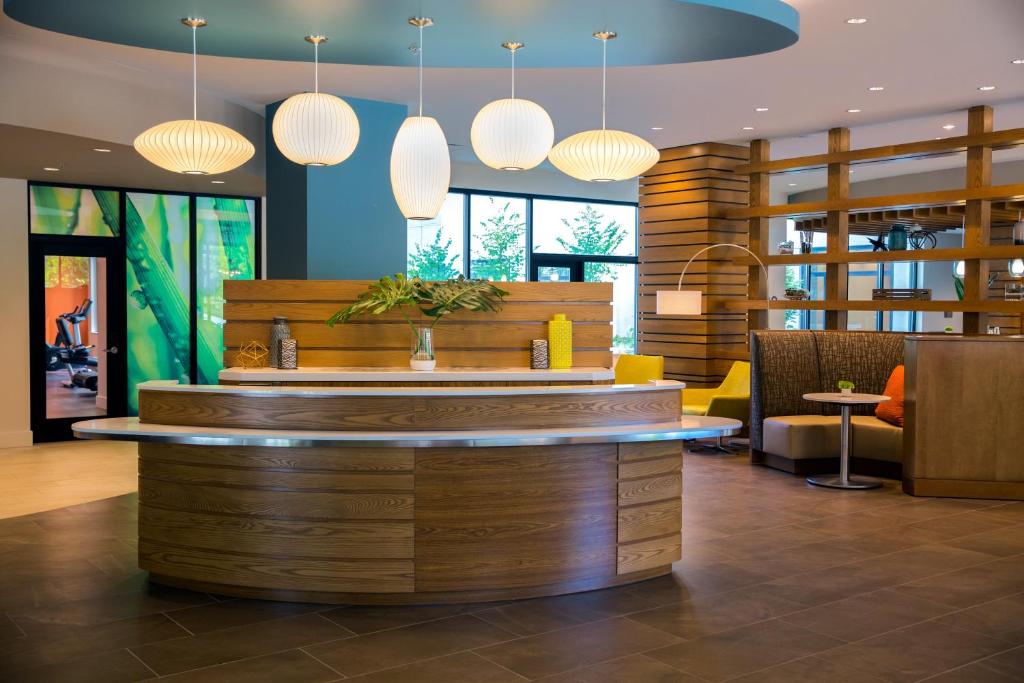 a lobby with a bar with lights above it at EVEN Hotel Seattle Downtown - Lake Union by IHG in Seattle