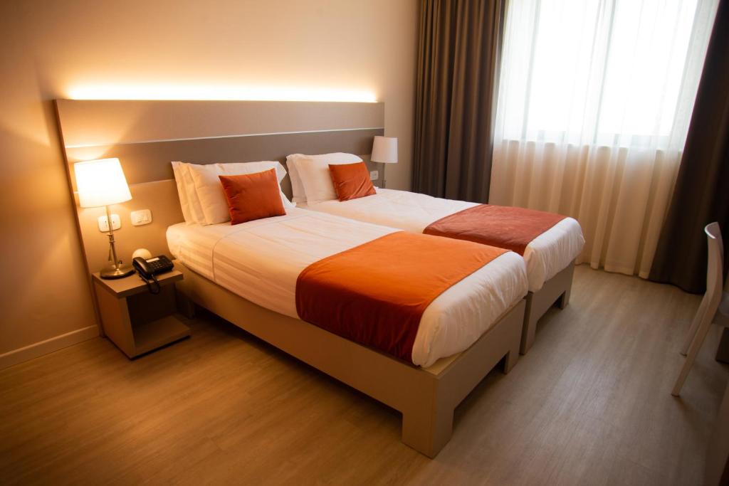 Postel nebo postele na pokoji v ubytování Hotel Glis