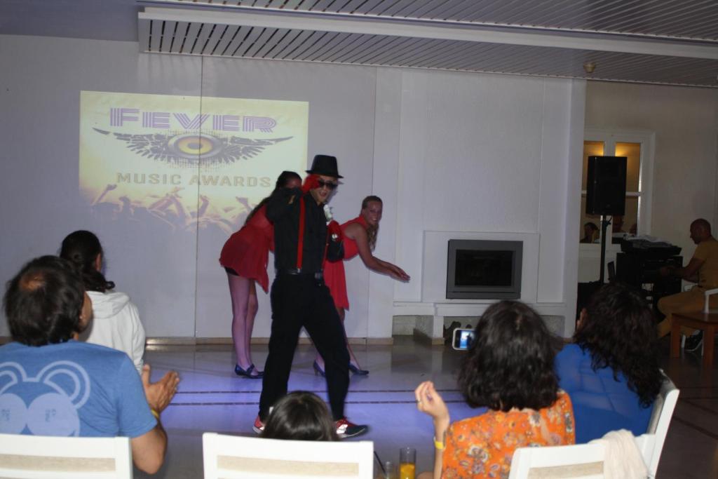 a man dancing in front of a group of people at Hydrele Beach Hotel & Village in Potokáki