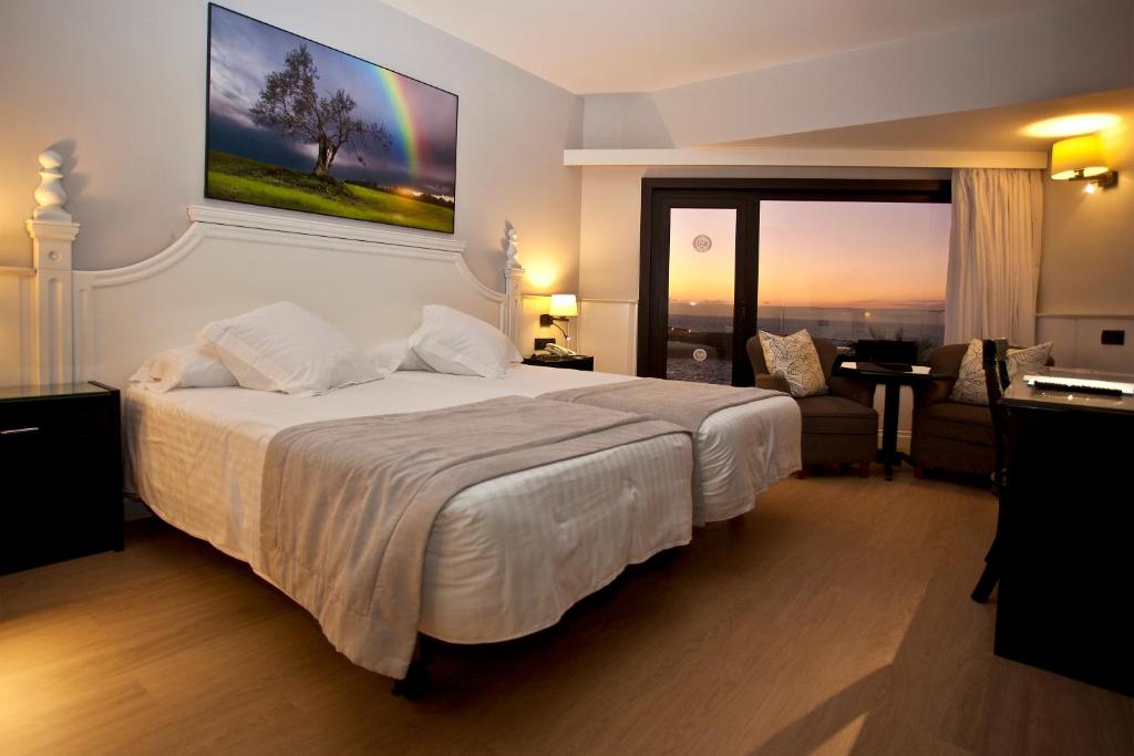 Postel nebo postele na pokoji v ubytování Hotel Vallemar