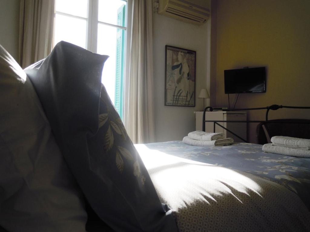 a bedroom with a large bed with a window at Blue Dolphin in Batsi