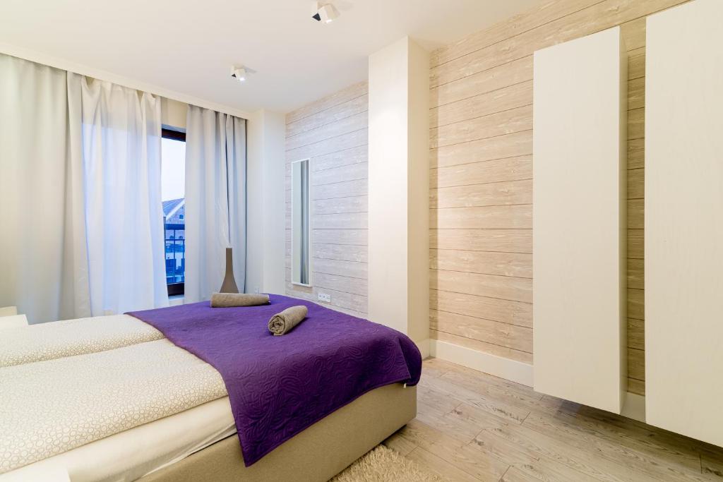 Posteľ alebo postele v izbe v ubytovaní Apartment Szafarnia 5