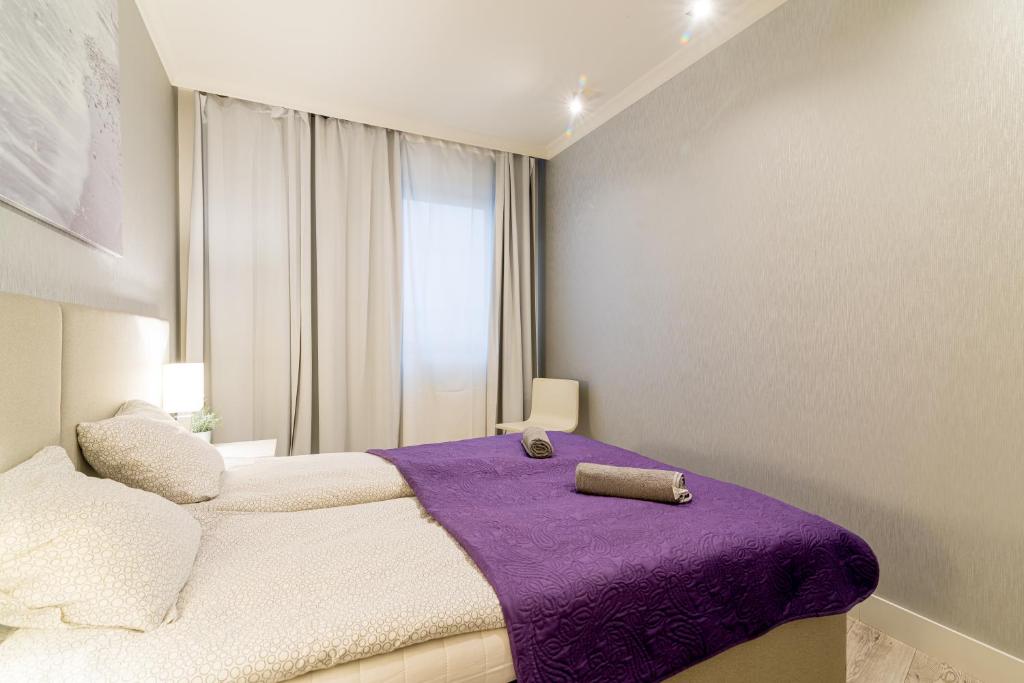 Posteľ alebo postele v izbe v ubytovaní Apartment Szafarnia 5