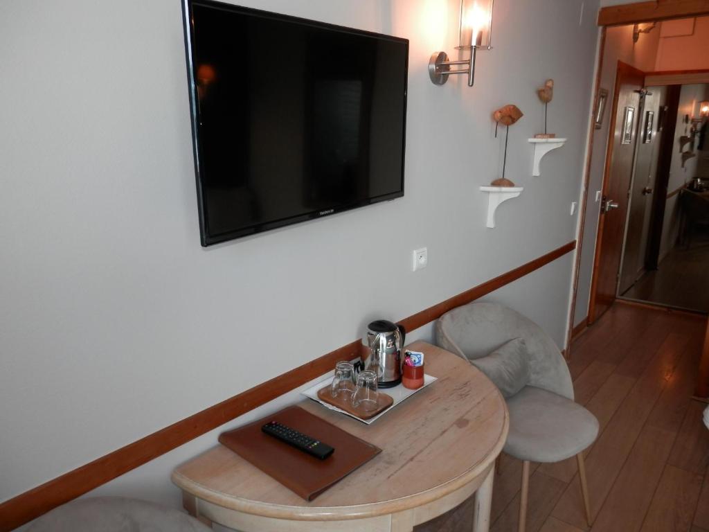 TV a/nebo společenská místnost v ubytování Hôtel La Caravelle