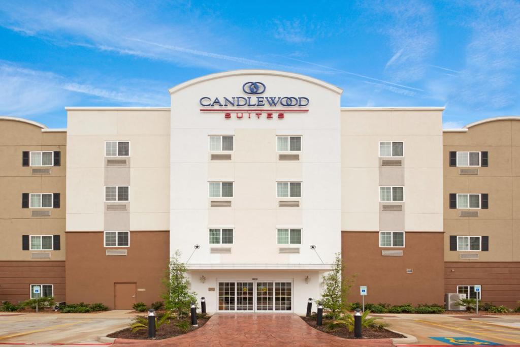 a large building with a sign on the front of it at Candlewood Suites San Antonio Downtown, an IHG Hotel in San Antonio