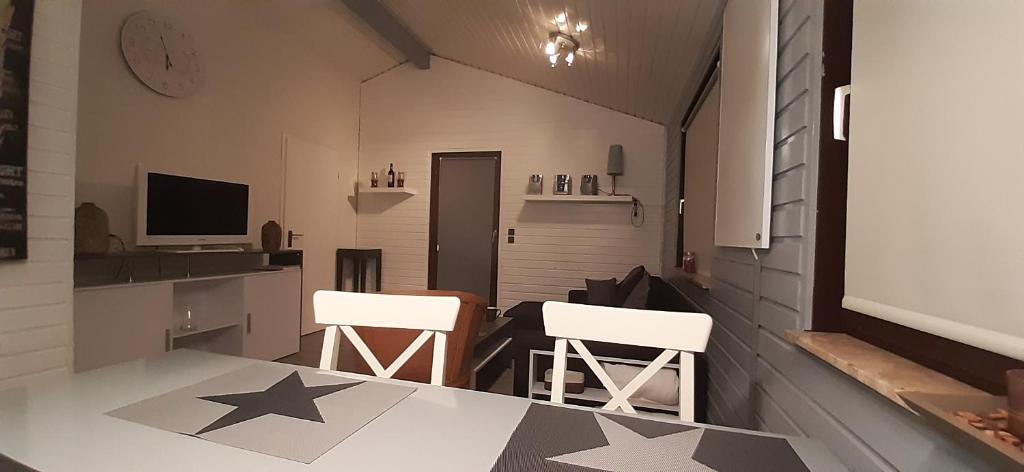 a kitchen with stars on the floor and two chairs at Ferienhaus uelsen in Uelsen