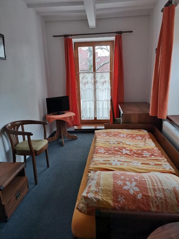 Postel nebo postele na pokoji v ubytování Penzion Pod Zámkem