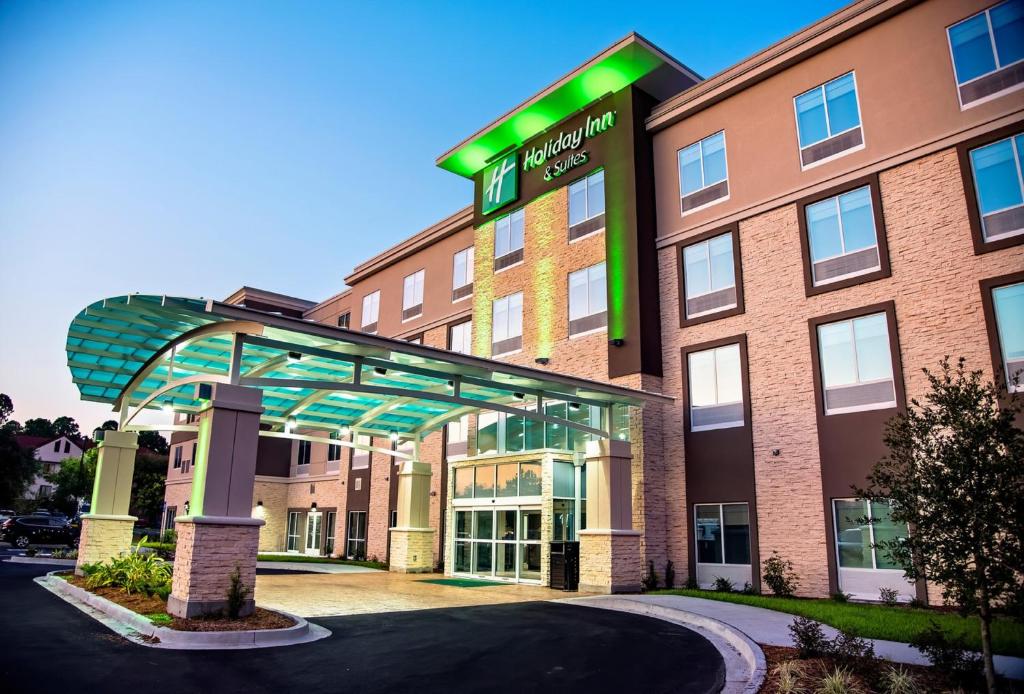 a hotel building with a walkway in front of it at Holiday Inn & Suites - Savannah Airport - Pooler, an IHG Hotel in Savannah