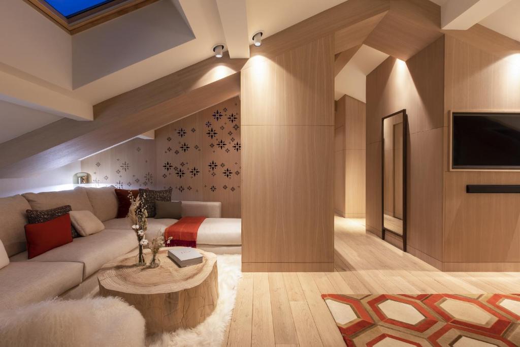 a living room with a couch and a table at Hôtel Mont-Blanc Chamonix in Chamonix