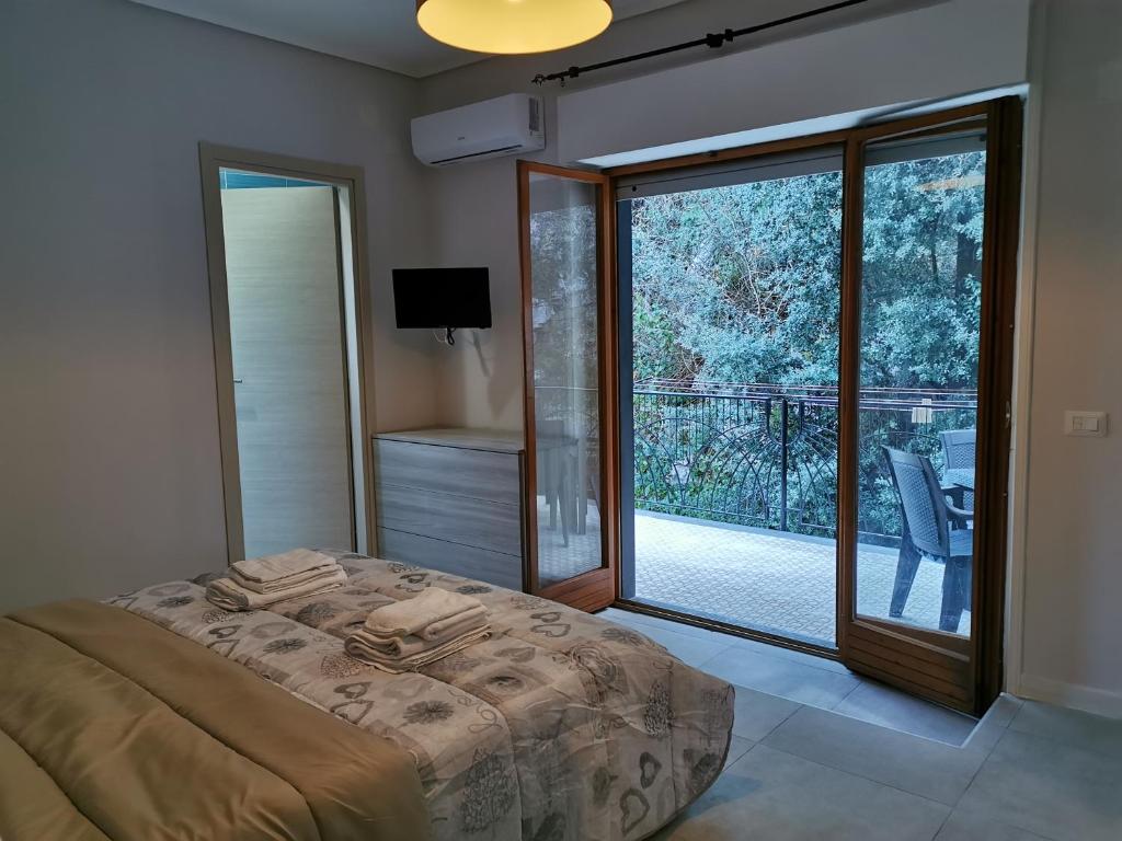 a bedroom with a bed and a large sliding glass door at Sorrento's Holidays Room 1 in Sorrento