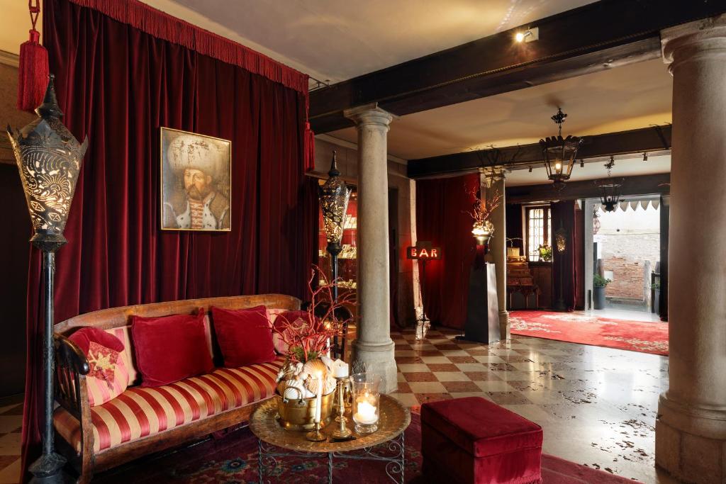 a living room with a couch and a table at Hotel Metropole Venezia in Venice