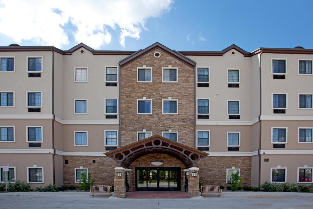 a large brick building with an entry way at Staybridge Suites San Antonio Sea World, an IHG Hotel in San Antonio