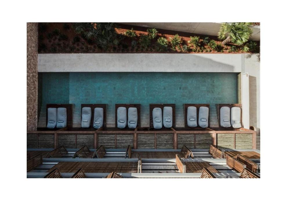 a group of benches in front of a building at OKU Ibiza in San Antonio