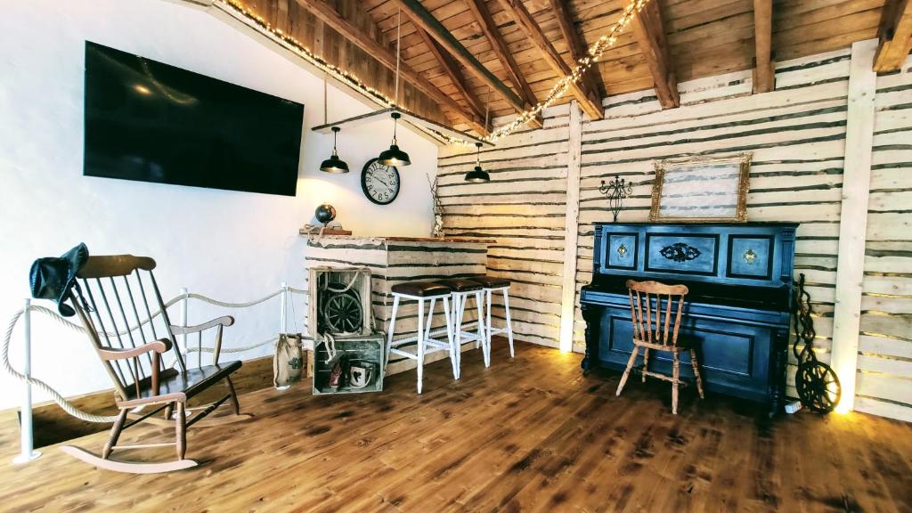 a living room with a blue stove and chairs at Xenos Apartments in Willingen