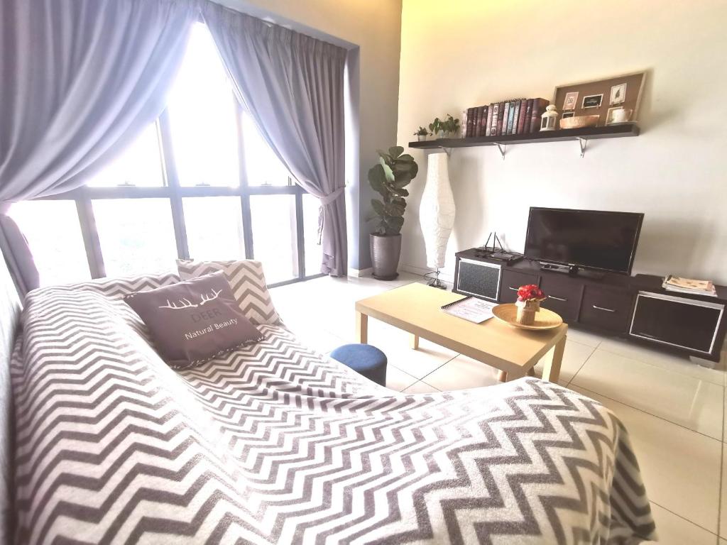 a bedroom with a bed and a desk and a window at CoZy Suite @ PJ & Sunway(2 Bedroom) in Petaling Jaya