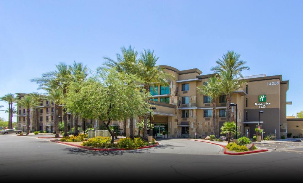 an empty street in front of a building with palm trees at Holiday Inn Scottsdale North- Airpark, an IHG Hotel in Scottsdale