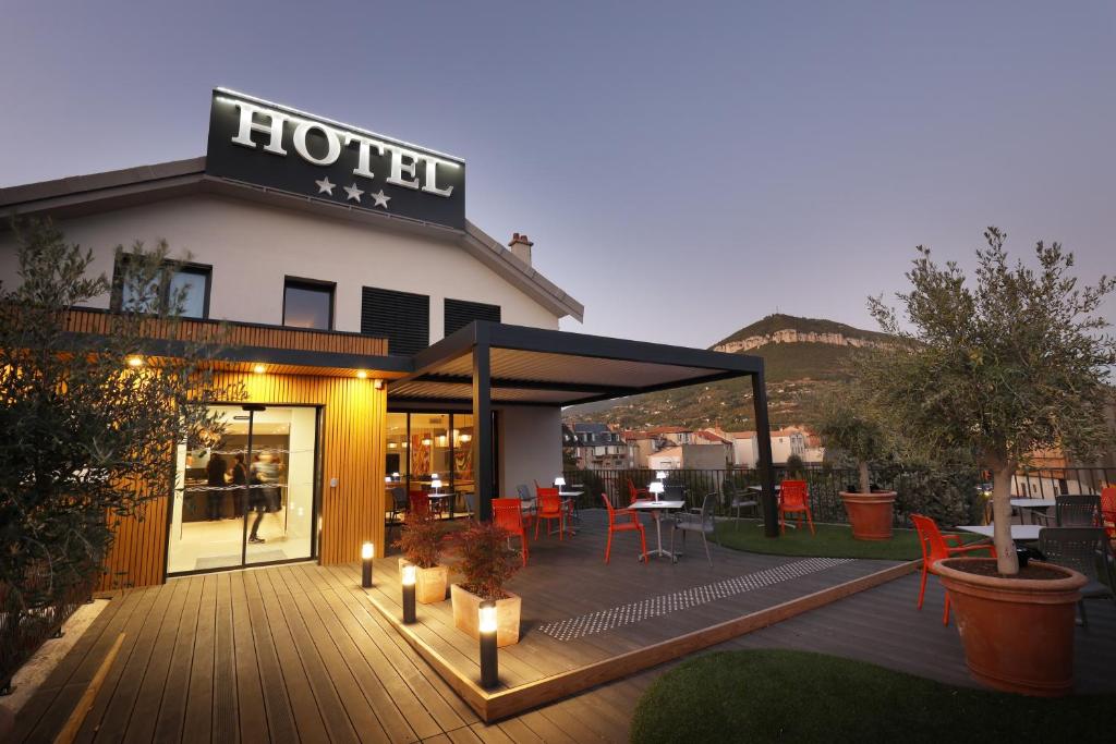 ein Hotel mit einer Terrasse mit Kerzen davor in der Unterkunft Hôtel la Capelle Millau in Millau