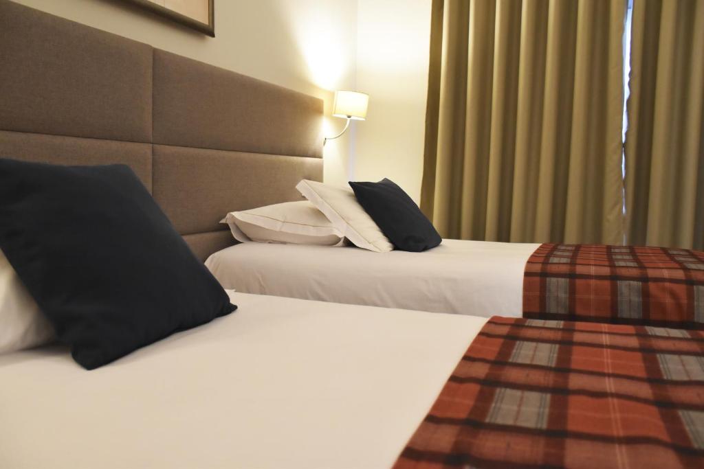 Postel nebo postele na pokoji v ubytování Hotel O Colmo