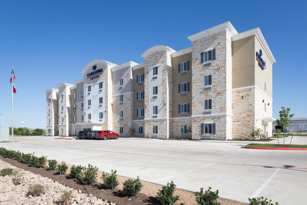 a large apartment building with a parking lot at Candlewood Suites - Buda - Austin SW, an IHG Hotel in Buda