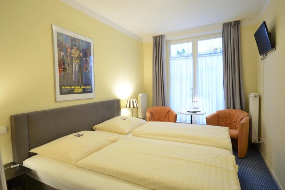 a bedroom with a large bed and a window at ALPHA Hotel Garni in Hamburg