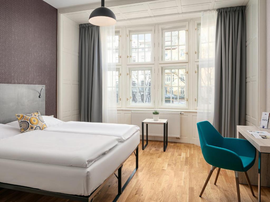 Łóżko lub łóżka w pokoju w obiekcie EA ApartHotel Melantrich
