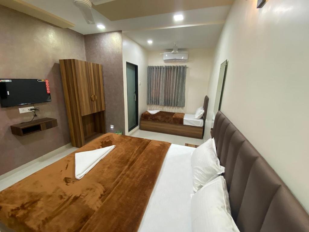 um quarto de hotel com uma mesa de madeira e uma cama em HOTEL DIVINE em Mumbai