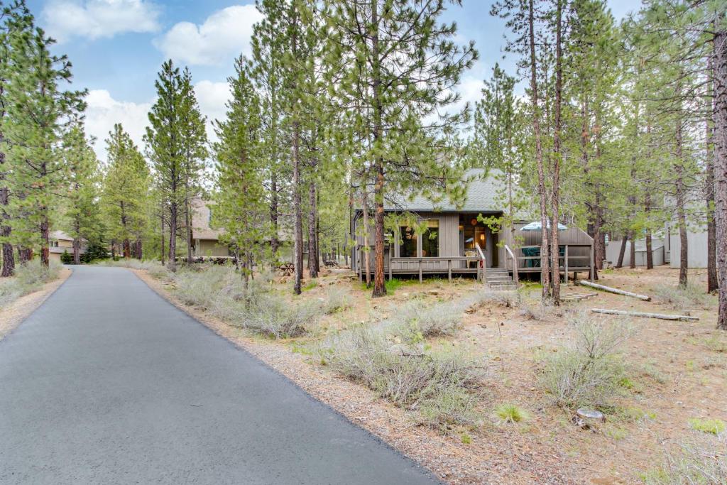 a house in the woods with a road leading to it at 7 Hare Lane in Sunriver