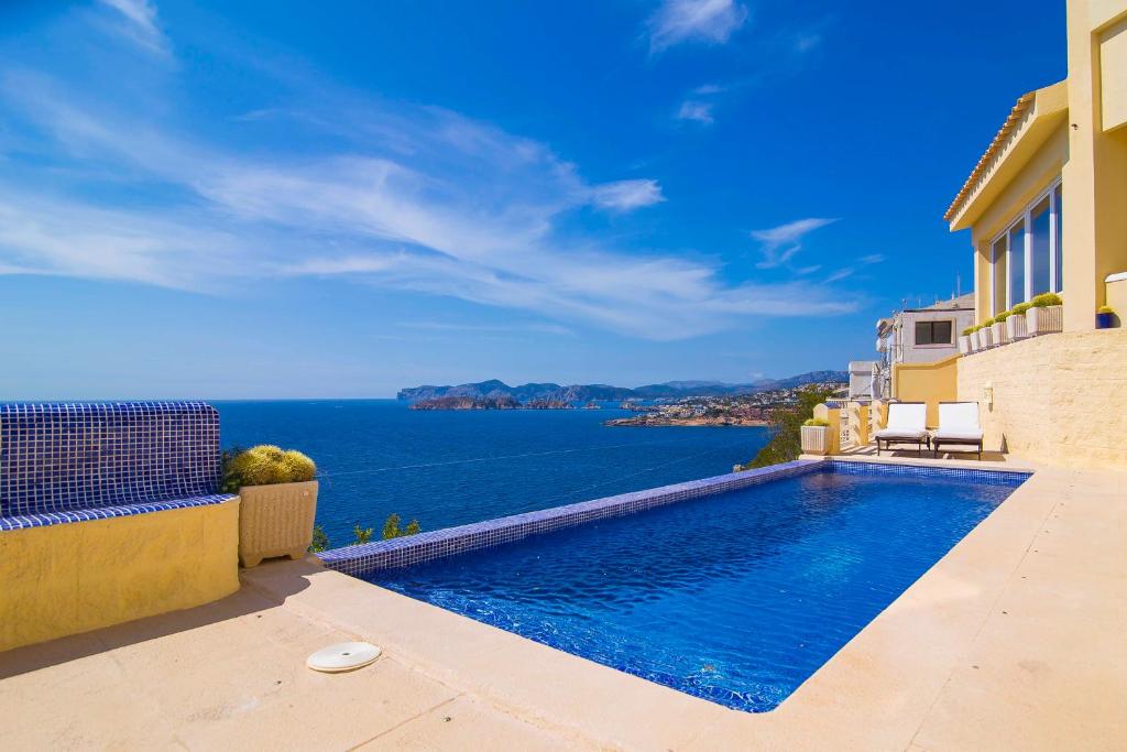 a villa with a swimming pool and a view of the ocean at El Toro Vistas al Mar in El Toro