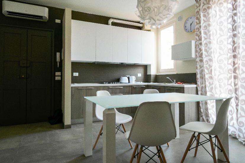 a kitchen with a table and chairs in a kitchen at Casa Myriam in Verona