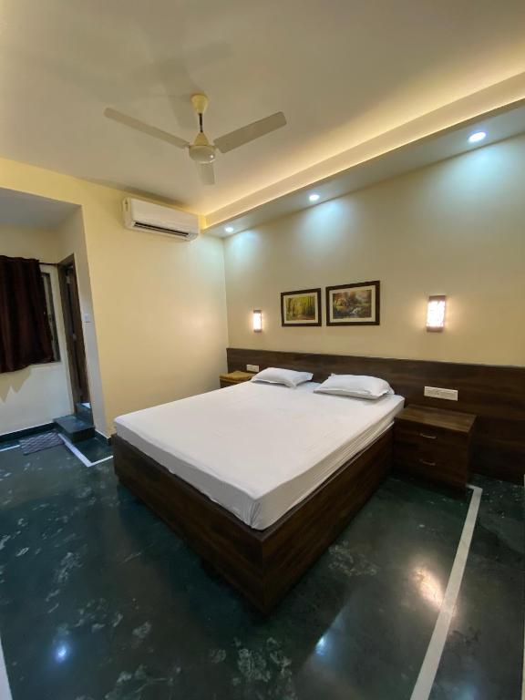 a bedroom with a large bed and a ceiling at Shivam Hotels in Kolkata