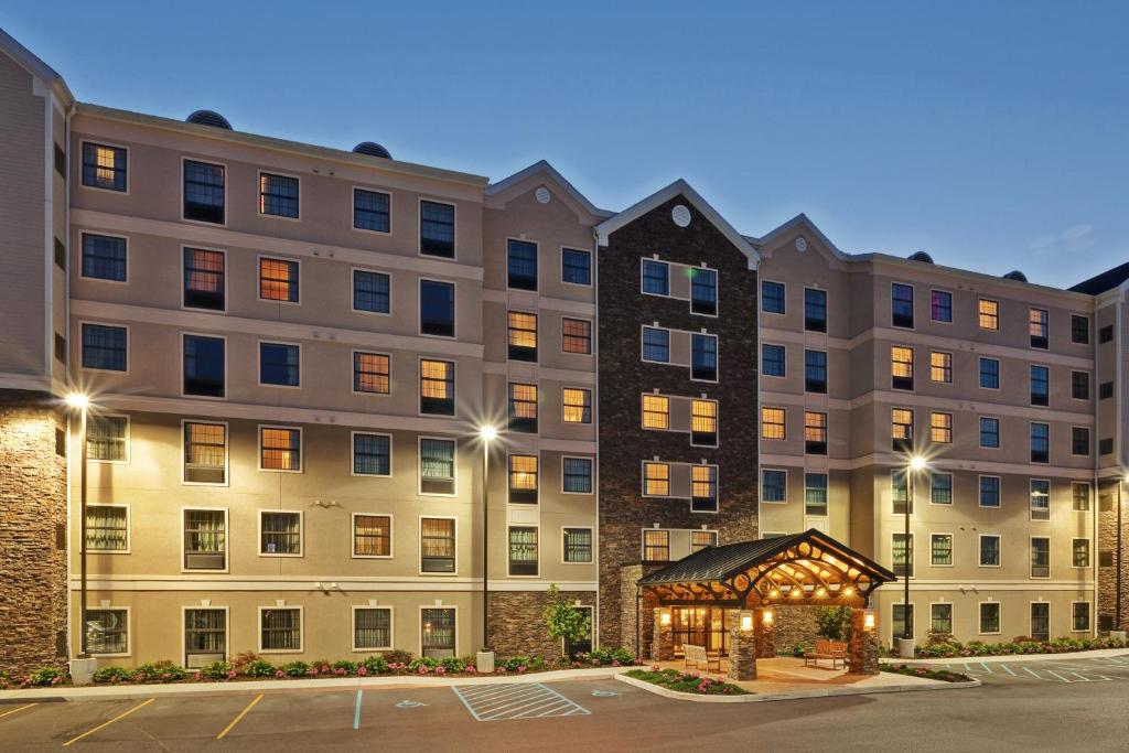 a large apartment building with a gazebo in a parking lot at Staybridge Suites Buffalo, an IHG Hotel in Buffalo