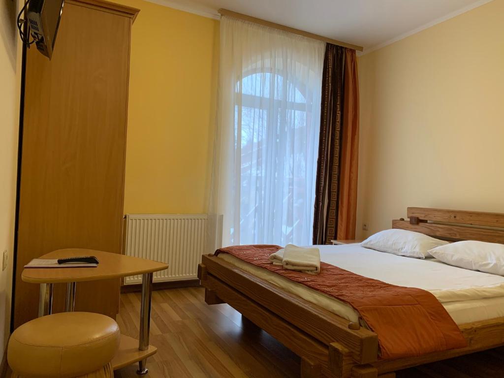 Postel nebo postele na pokoji v ubytování Hotel Kalyna