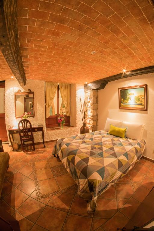 Postel nebo postele na pokoji v ubytování Hotel Mesón de los Remedios