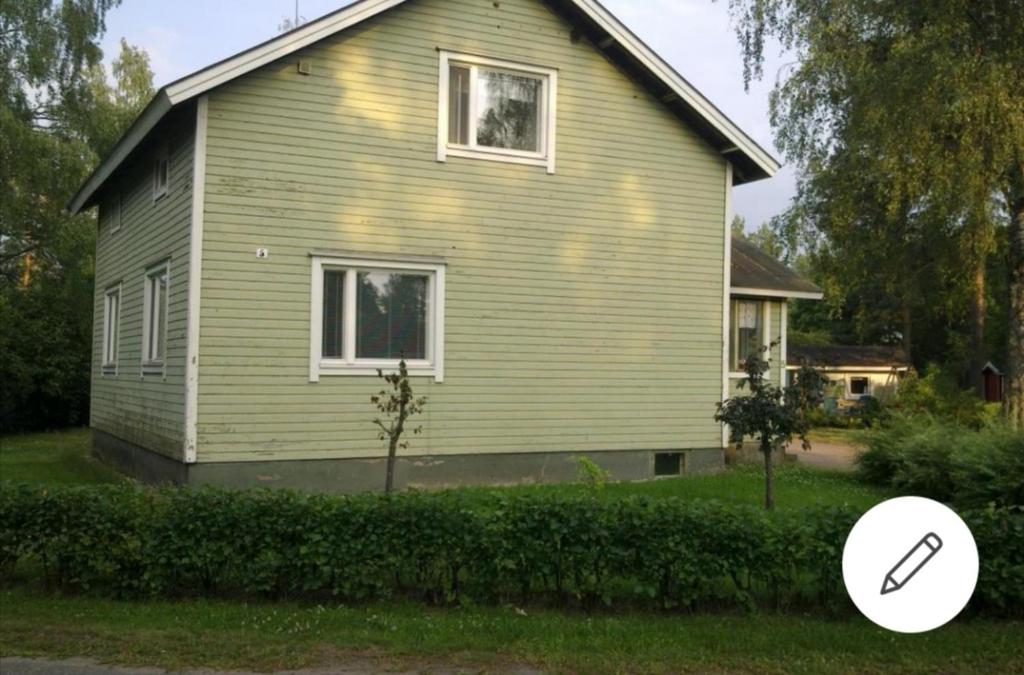 a house with a magnifying glass in front of it at Kouvola Guest house in Kouvola