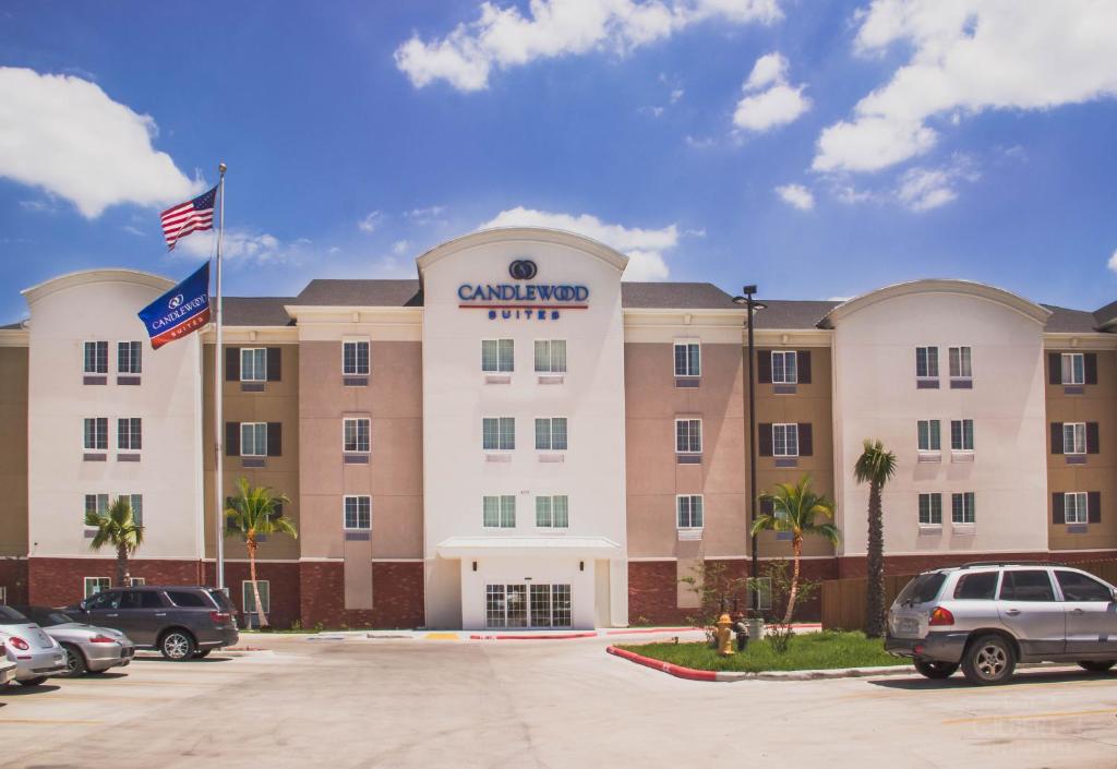 a large hotel with cars parked in a parking lot at Candlewood Suites Harlingen, an IHG Hotel in Harlingen
