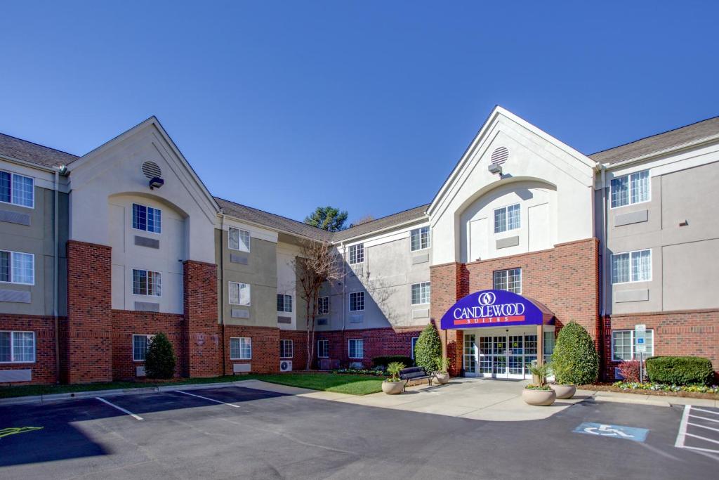 an image of an apartment complex with a parking lot at Candlewood Suites Raleigh Crabtree, an IHG Hotel in Raleigh