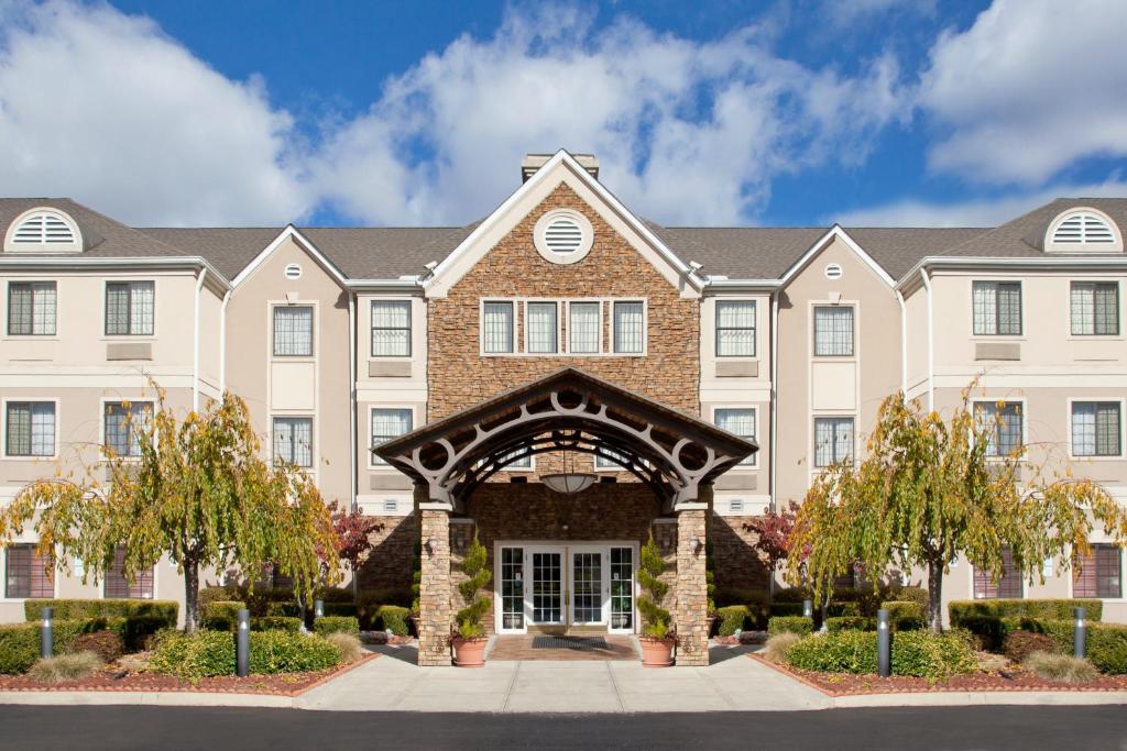 a large apartment building with an entry way at Staybridge Suites Columbus-Airport, an IHG Hotel in Columbus