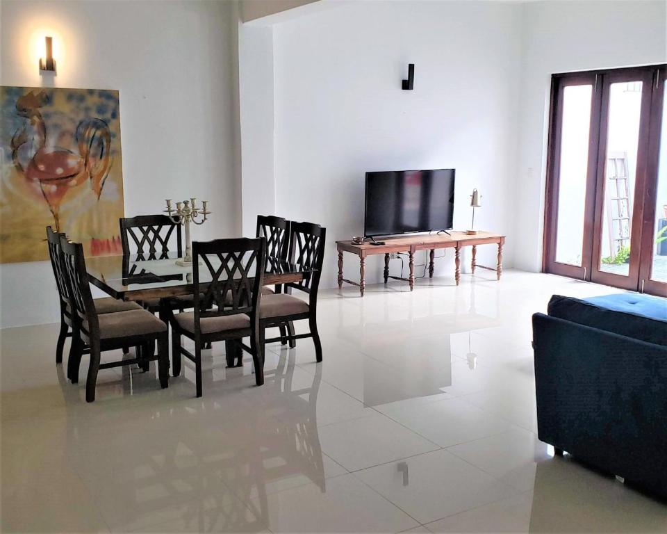 a dining room with a table and chairs and a tv at KASA The Lofts 202 HUGE 2 Bed 2 bath Washer Dryer in San Juan