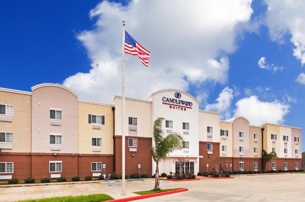 a hotel with an american flag in front of it at Candlewood Suites - Texas City, an IHG Hotel in Texas City