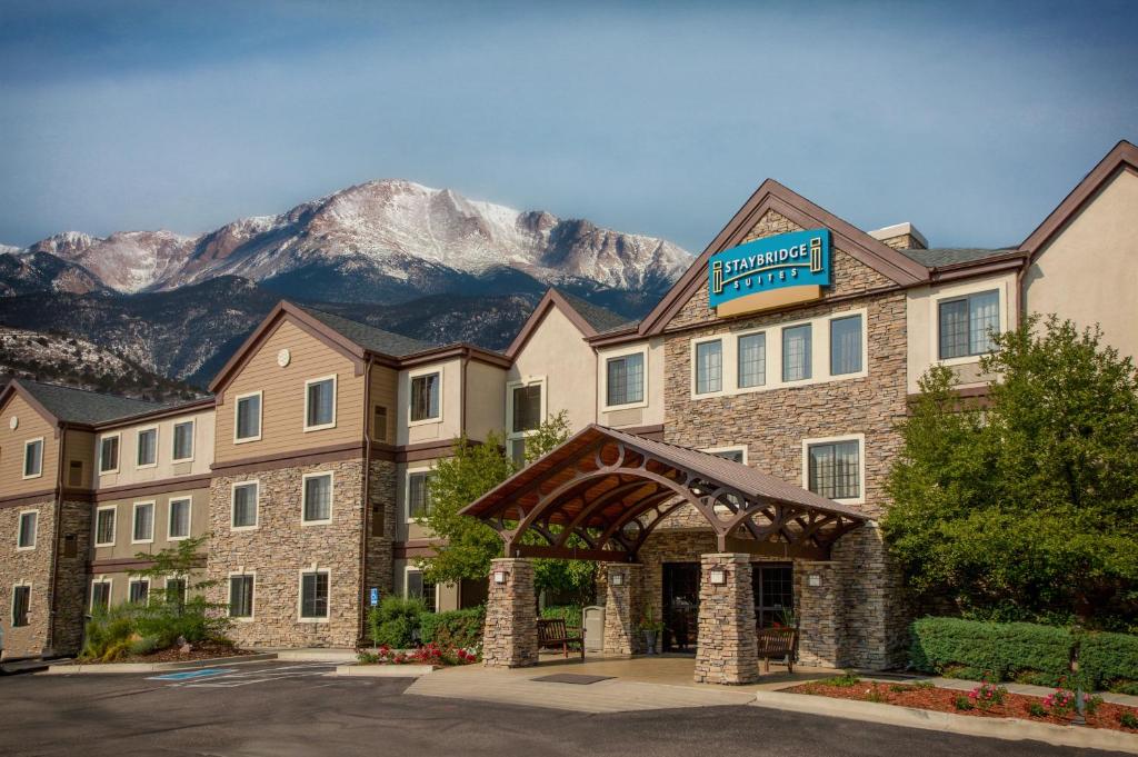 a hotel with a mountain in the background at Staybridge Suites Colorado Springs North, an IHG Hotel in Colorado Springs