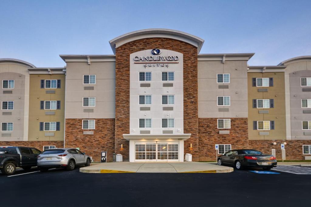 ein großes Gebäude mit Autos auf einem Parkplatz in der Unterkunft Candlewood Suites Smyrna - Nashville , an IHG Hotel in Smyrna