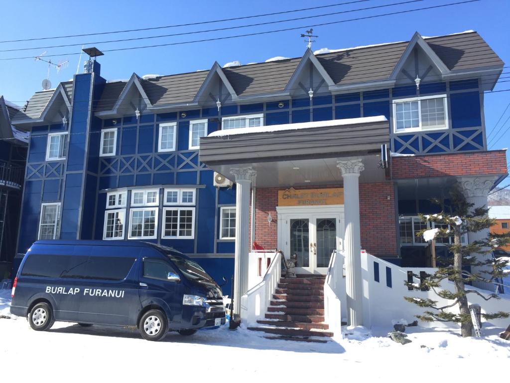 a blue van parked in front of a house at CHALET BURLAP FURANUI in Furano