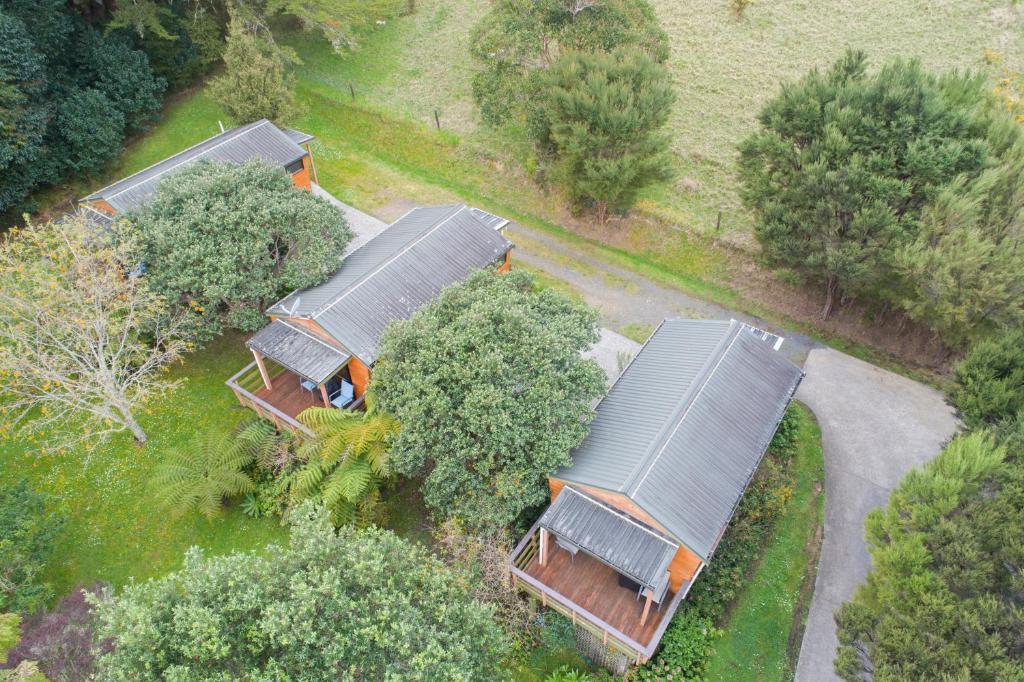 an overhead view of a group of houses with trees at The Cowshed Wairoro Park - Russell Holiday Home in Russell