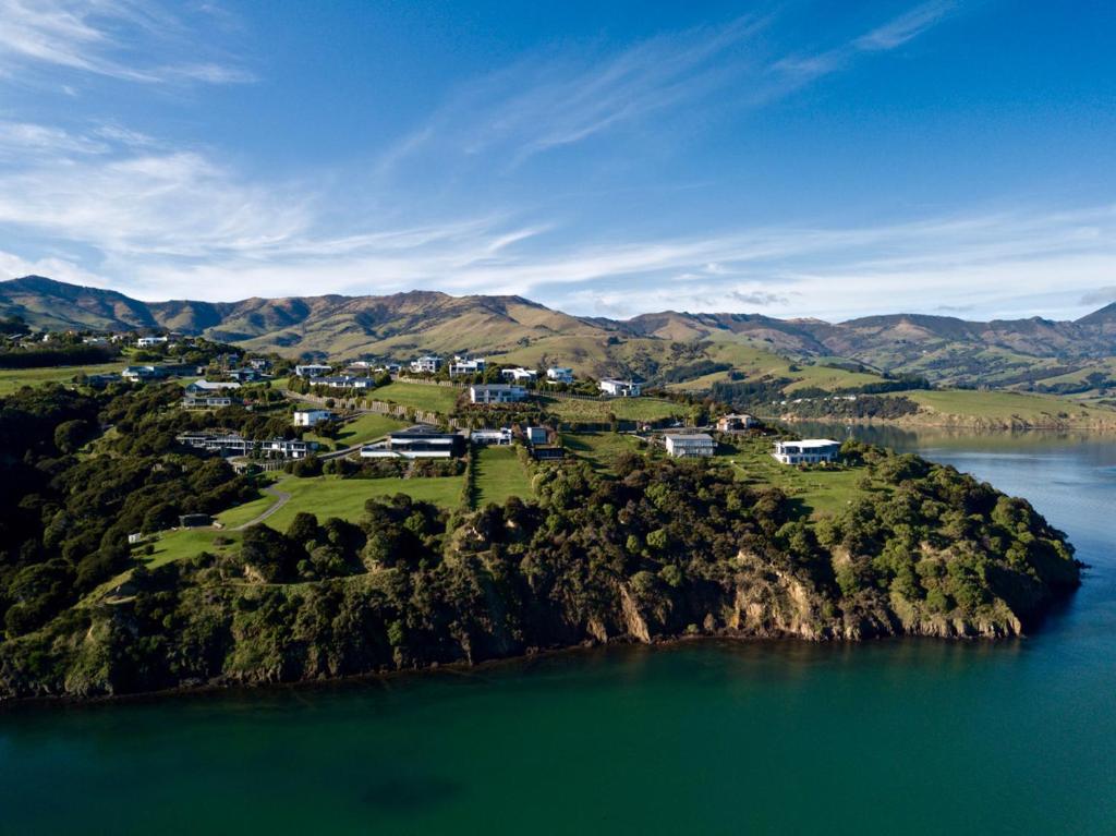 an island in the middle of a body of water at Hector's Tiny House - Akaroa Holiday Home in Akaroa
