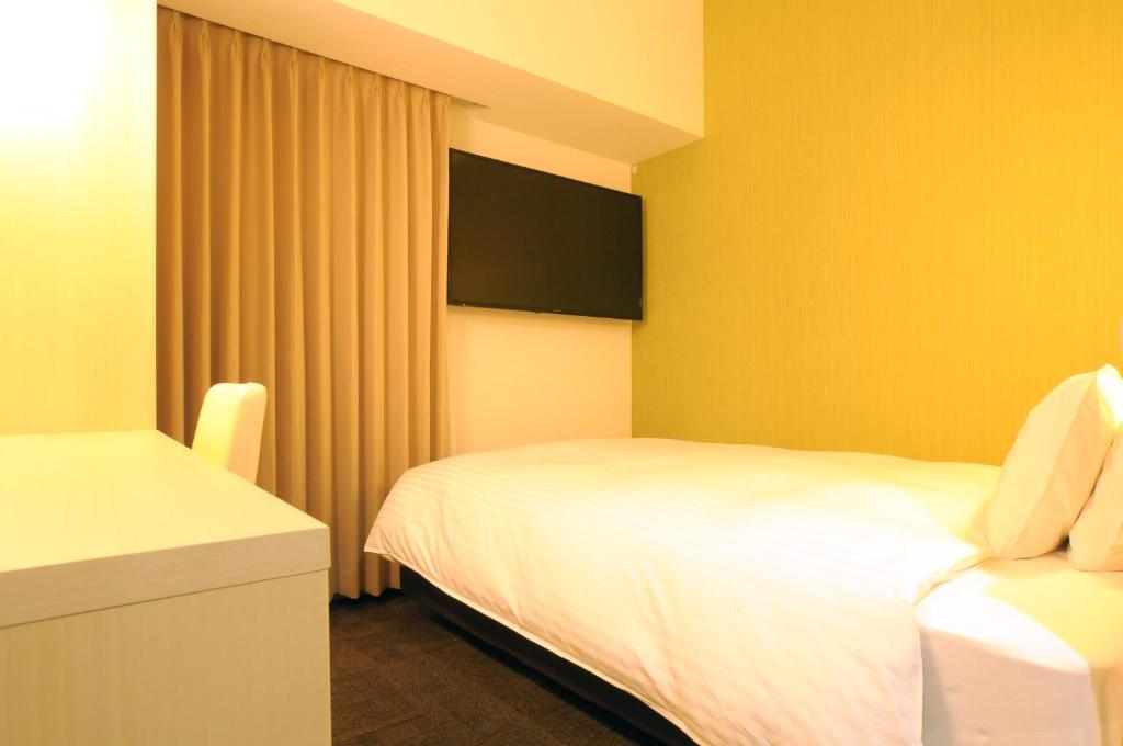 Postel nebo postele na pokoji v ubytování AB Hotel Tokai Otagawa